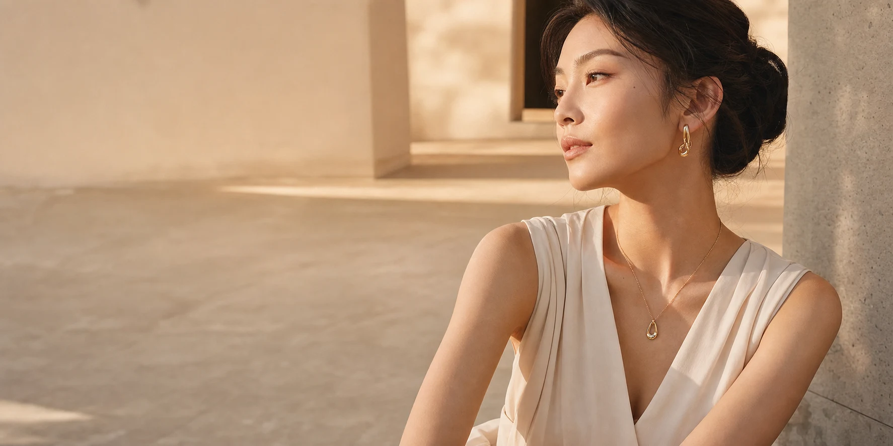 Woman wearing delicate VOW & GLEAM jewelry